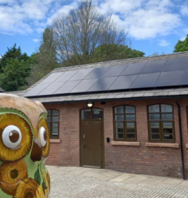 Photograph of outbuilding at Court Hey Park with owl statue in the foreground