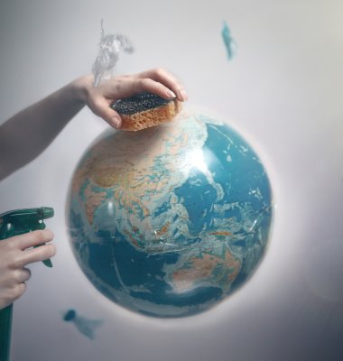 Graphic of a womans hand cleaning plant Earth with a sponge
