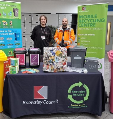 Photograph of Recycling Engagement team members at a stall promoting mobile recycling