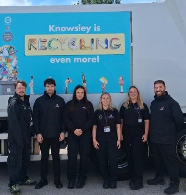 Photograph of Recycling Engagement Team in front of recycling vehicle with service branding.
