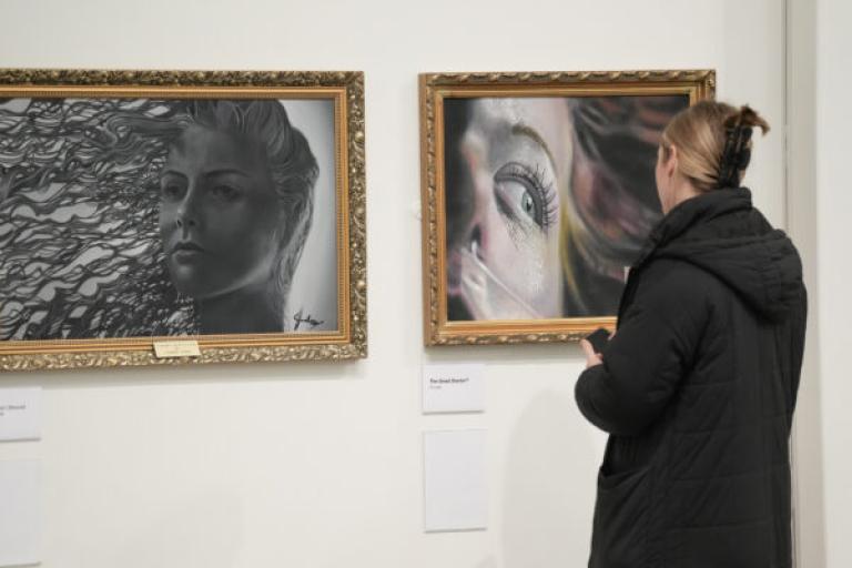Lady looking at a painting.