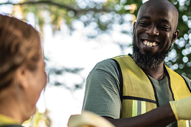A photograph of two park volunteers smiling