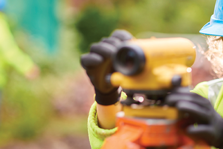 A photograph of a female site surveyor using equipment