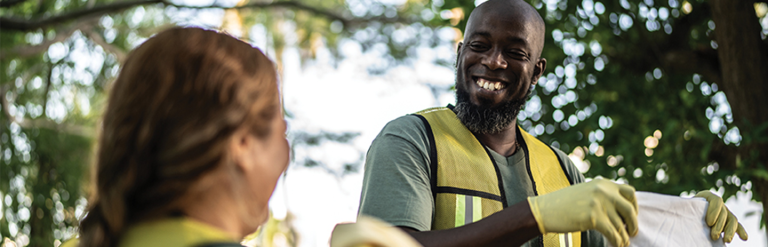 A photograph of two park volunteers smiling