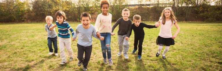 Photograph of children in a field running forwards